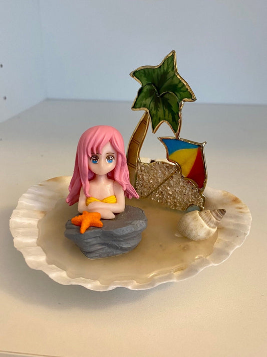 Mermaid on a shell beach with palm tree, shells, and umbrella pink hair