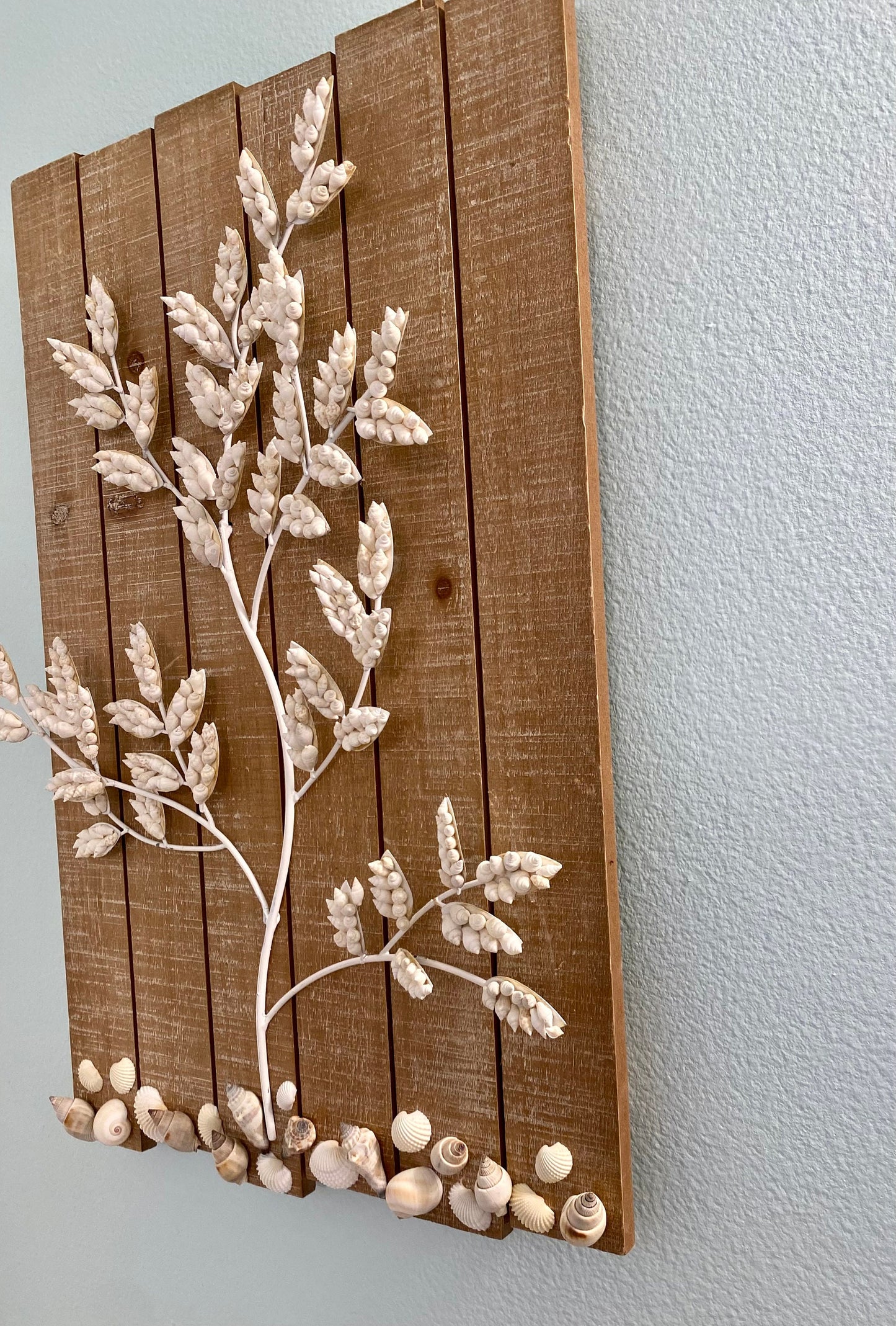 Wall Hanging Wood plank with white metal branches decorated with white shells